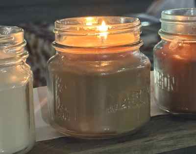 FFM staff member puts the finishing touches on one of our signature candles.